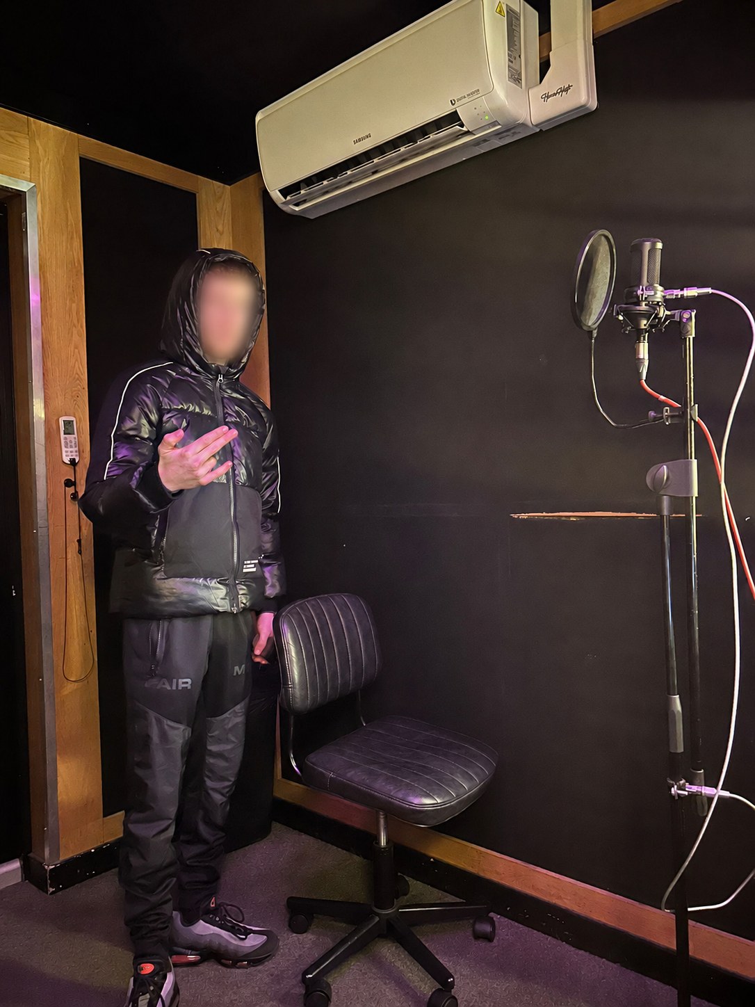 An artist in the vocal booth at Studio Solutions
